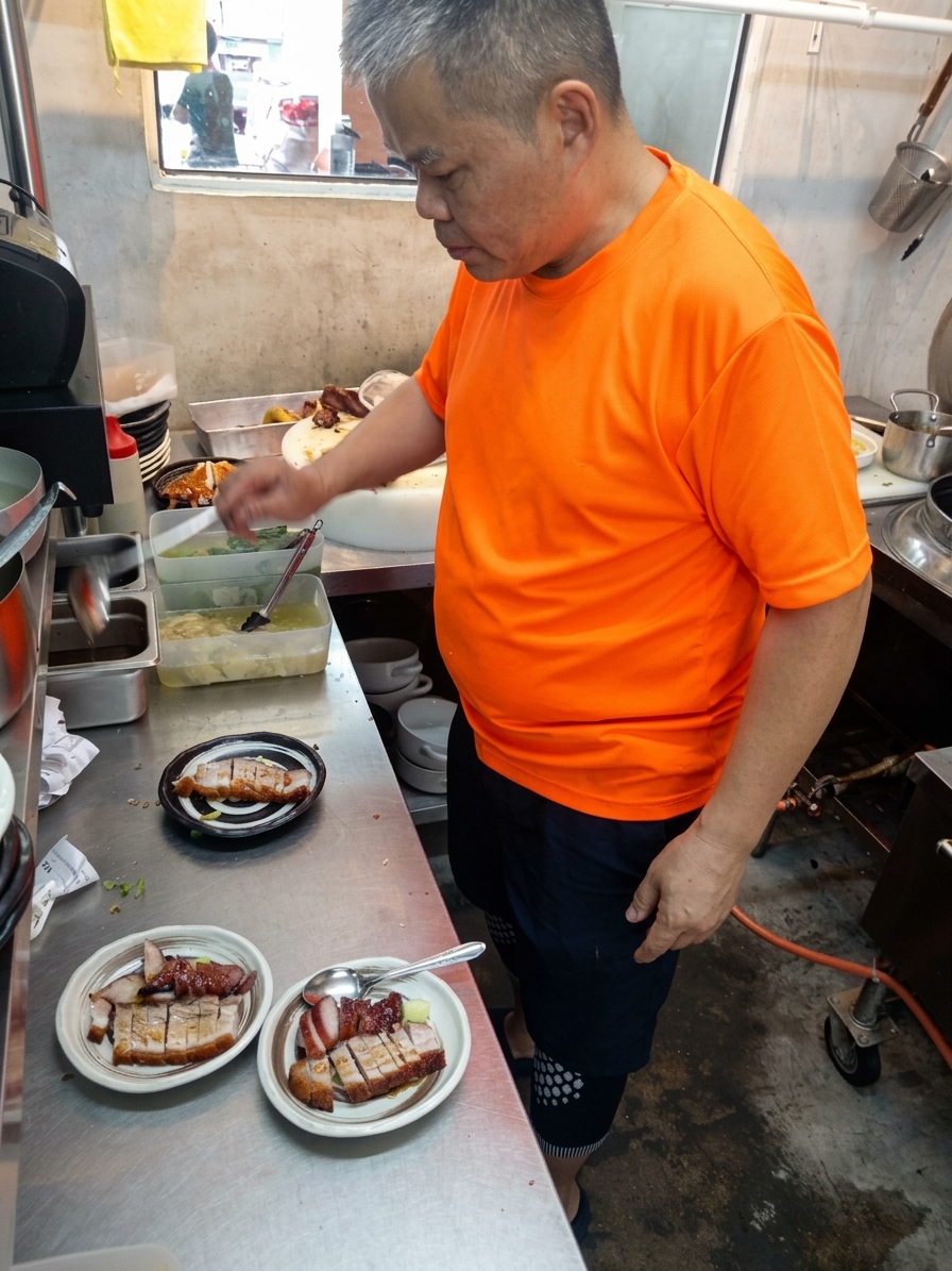Chef preparing roasted meats at Chok Sifu